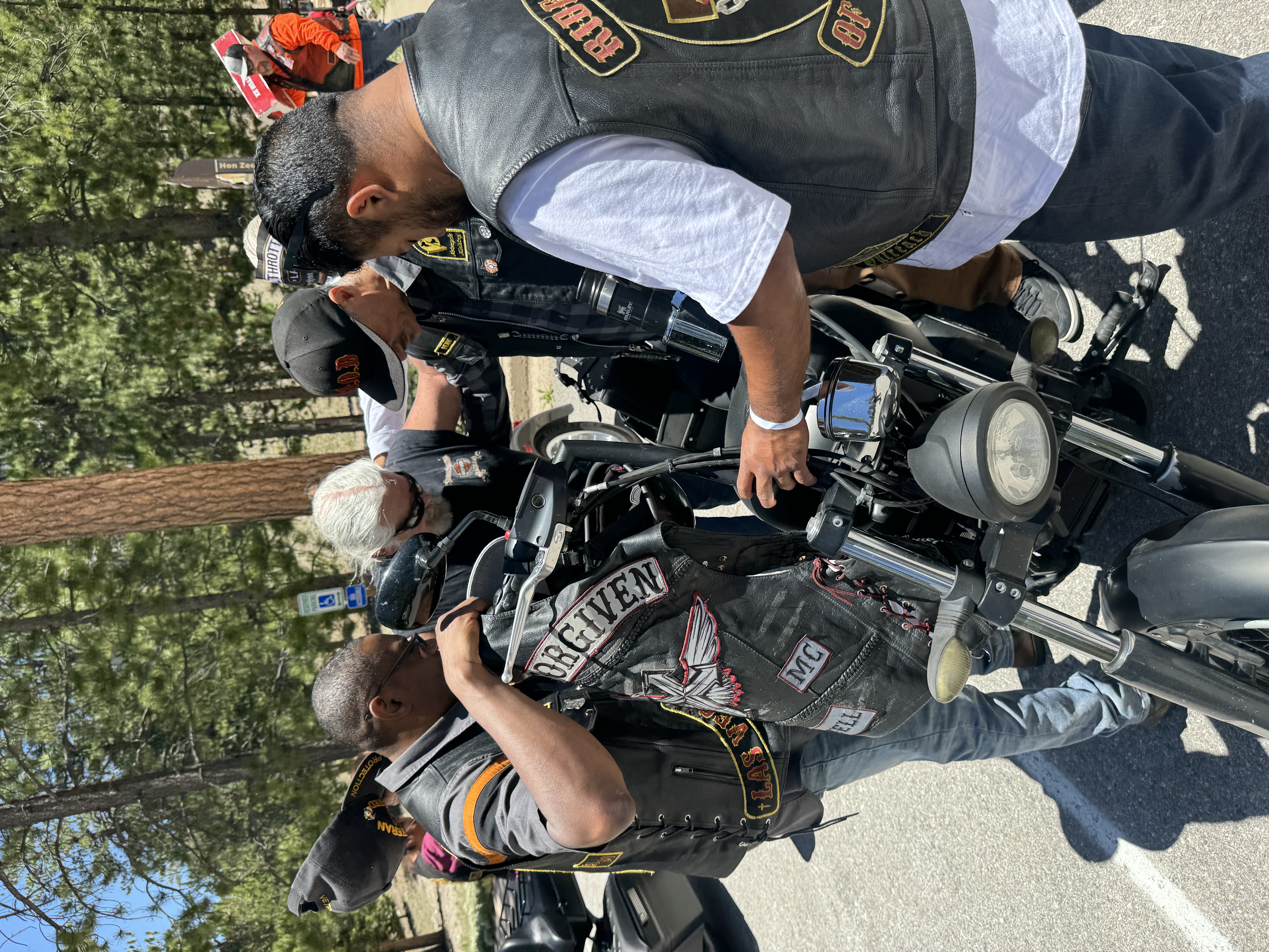 Riders praying over a motorcycle